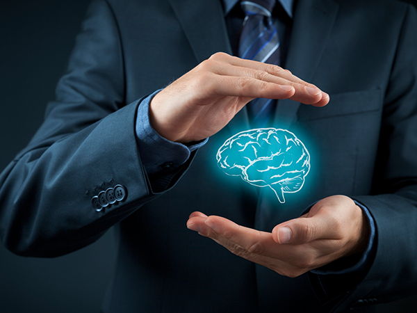 businessman protecting graphic of human brain in his hands